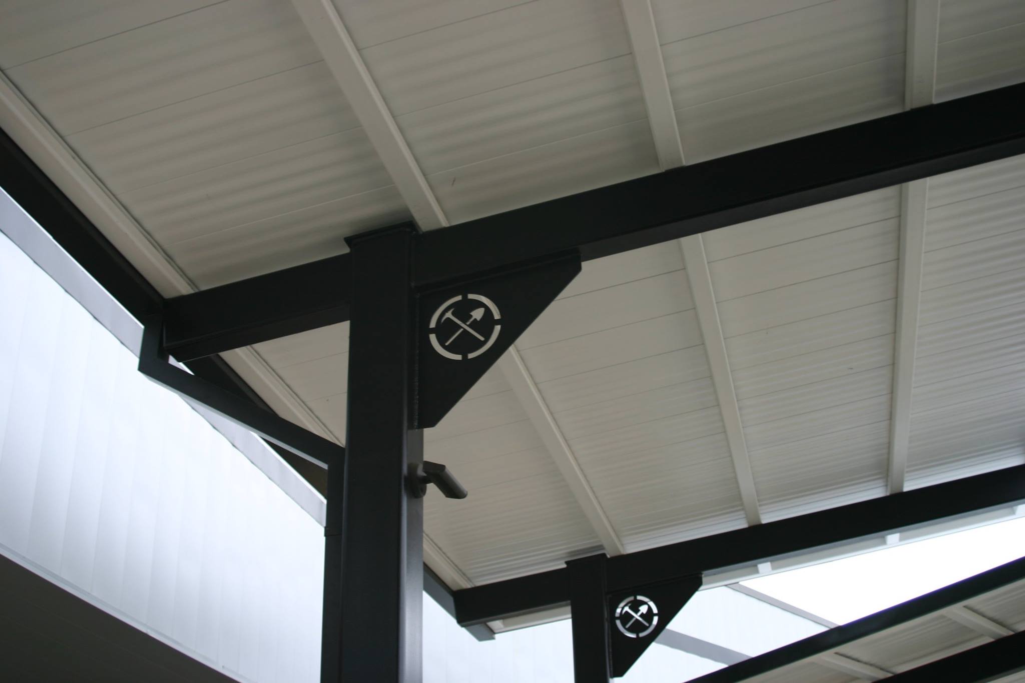 covered walkway outside school with school's logo